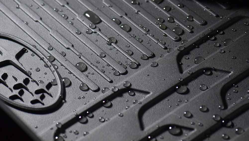Closeup shot of the AdventureGuard floor mat with spilled water droplets.